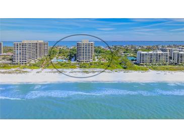 Aerial view of beachfront condo building with private beach access and stunning Gulf views at 1211 Gulf Of Mexico Dr # 704, Longboat Key, FL 34228