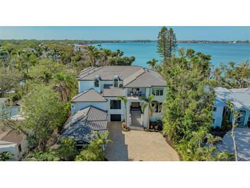 Beautiful waterfront home with lush tropical landscaping, multi-car garage and a grand staircase entrance at 1540 Hillview Dr, Sarasota, FL 34239