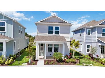 Charming two-story home with manicured lawn and inviting front porch at 164 Eagleston Ln, Sarasota, FL 34240