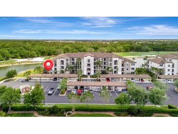 Beautiful condo complex with covered parking, landscaping, and tranquil water views at 17118 Vardon Ter # 101, Bradenton, FL 34211