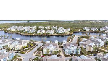 Beautiful waterfront community featuring colorful two-story homes, lush landscaping, and a tranquil waterway at 319 Compass Point Dr # 201, Bradenton, FL 34209