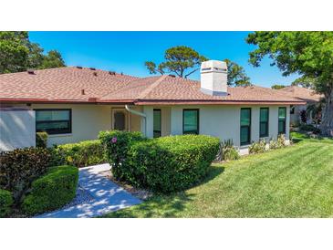 Charming single-story home features a well-maintained lawn, mature landscaping, and a welcoming facade at 6102 Penny Ln, Bradenton, FL 34207