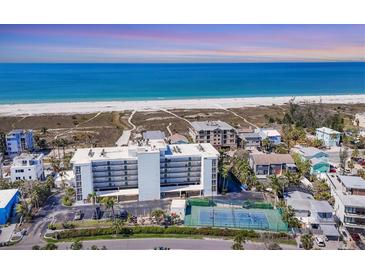 Breathtaking aerial view of beachfront condo, white sands, blue waters, and community tennis courts at 625 Beach Rd # 207, Sarasota, FL 34242