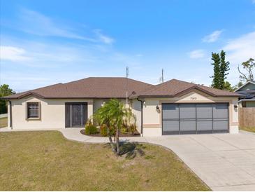 Charming single-story home with a well-manicured lawn and a two-car garage, perfect for comfortable living at 7145 Mamouth St, Englewood, FL 34224
