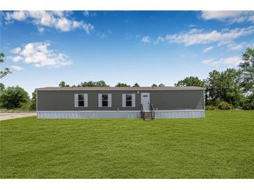 Charming single-story home featuring a well-maintained lawn and classic design elements at 8414 Sweden Blvd, Punta Gorda, FL 33982