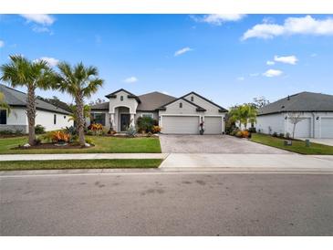 Beautiful single-Gathering home with lush landscaping and a three-car garage at 12715 Wheatgrass Ct, Parrish, FL 34219