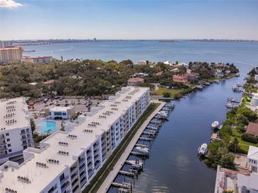 Stunning aerial view of waterfront condos with boat docks and beautiful bay views on a sunny day at 1709 N Tamiami Trl # 318, Sarasota, FL 34234