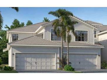 Charming two-story home featuring a spacious two-car garage, palm trees, and well-maintained landscaping at 5616 Summit Pointe Cir # 101, Bradenton, FL 34210
