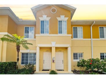 Inviting condo exterior featuring a vibrant color scheme and well-maintained landscaping at 12971 Tigers Eye Dr, Venice, FL 34292
