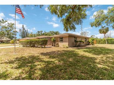 Charming single-story home with well-maintained landscaping and an American flag waving in the front yard at 3600 Aster Dr, Sarasota, FL 34233