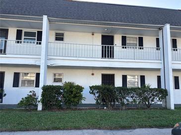 Charming two-story condo with black shutters, white railings, and well-maintained landscaping at 4502 3Rd Street W Cir # 242, Bradenton, FL 34207