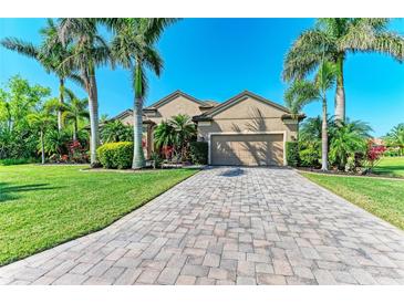 Charming one-story home showcasing a paver driveway and a meticulously maintained lawn at 618 148Th Ne Ct, Bradenton, FL 34212