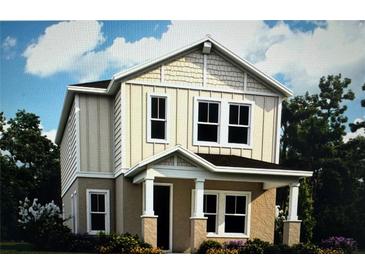 Charming two-story home with neutral siding, decorative shingles, covered porch, and manicured landscaping at 149 Thorne Ln, Sarasota, FL 34240