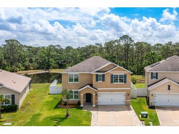 Two-story home featuring a well-manicured lawn and pond view at 259 Tierra Verde Way, Bradenton, FL 34212