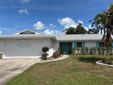 Charming single-story home featuring a well-maintained lawn, blue accents, and a welcoming entrance at 3123 Chase Cir, Sarasota, FL 34231