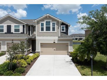 Townhome exterior with a two-car garage and manicured landscaping at 5543 Pleasantview Ct, Bradenton, FL 34211