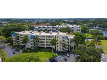 Beautiful condominiums featuring multiple stories, lush landscaping, and a serene lakeside setting at 825 S Osprey Ave # 302, Sarasota, FL 34236