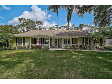 Charming single-story home with a well-manicured lawn, inviting front porch, and classic shutters at 13612 11Th E Ter, Bradenton, FL 34212