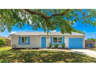 Charming single-story home with a well-maintained lawn, blue shutters, and a matching blue garage door at 2237 Lockwood Meadows Cir, Sarasota, FL 34234