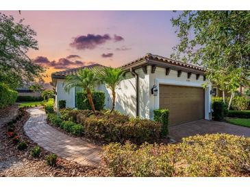 Charming single-story home with a two-car garage, lovely landscaping, and a brick walkway at 4704 Stafford Ct, Palmetto, FL 34221