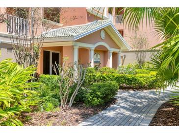 Inviting entrance with manicured landscaping and a charming covered walkway to the building's entrance at 5238 Manorwood Dr # 3C, Sarasota, FL 34235