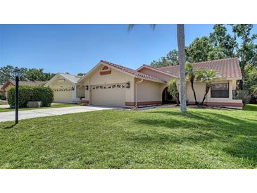 Charming single-story home featuring a red tile roof and well-manicured lawn in a beautiful neighborhood at 6128 Nicole Dr, Sarasota, FL 34243