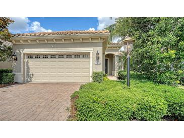 Charming home exterior featuring a brick driveway and lush landscaping at 7158 Westhill Ct, Lakewood Ranch, FL 34202