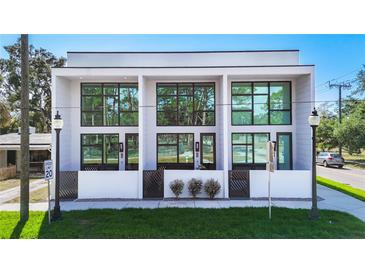 Modern townhome showcasing sleek architecture, large windows, and inviting private entrances at 941 N Osprey Ave, Sarasota, FL 34236