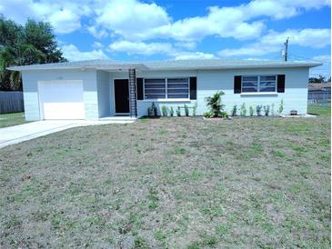 Charming single-story home featuring a well-maintained front yard and an attached garage at 1102 Temple Ave, Bradenton, FL 34207