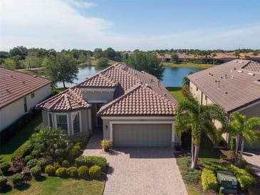 Beautiful one-story home with lush landscaping and stunning lake view at 12740 Del Corso Loop, Lakewood Ranch, FL 34211