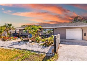 Charming single-story home featuring a lush, meticulously landscaped front yard and one car garage at 2929 Siesta Dr, Venice, FL 34293