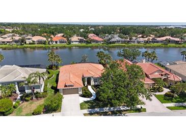 Charming single-story home boasts a new tile roof and is situated on a picturesque lakefront property at 4961 Sabal Lake Cir, Sarasota, FL 34238