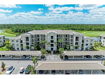 Stunning aerial view of a condo building with covered parking and lush landscaping at 18028 Gawthrop Dr # 203, Bradenton, FL 34211