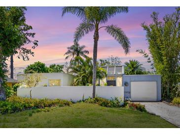 Charming single-story home with lush landscaping and a unique architectural design in a tropical setting at 2720 Herwald St, Sarasota, FL 34231
