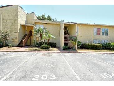 Inviting condo exterior with well-maintained landscaping and assigned parking spaces at 3403 Clark Rd # 203, Sarasota, FL 34231