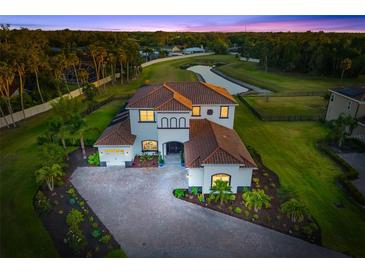 Stunning home with beautiful tile roof, lush landscaping, brick paver driveway, and pond view at 4712 Margutta Ct, Sarasota, FL 34240