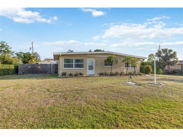 Charming tan home with well-manicured lawn and mature landscaping, offering great curb appeal at 516 45Th Street W Ct, Palmetto, FL 34221