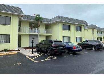 Inviting condo building featuring a well-maintained exterior and convenient parking at 6703 Midnight Pass Rd # 206, Sarasota, FL 34242
