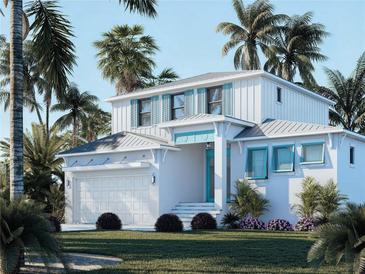 Beautiful two-story home with turquoise shutters, a two-car garage, and lush landscaping at 105 Island Cir, Sarasota, FL 34242
