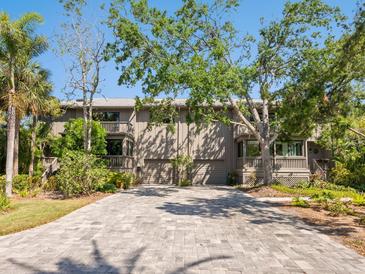 Charming exterior with a driveway, mature trees and multiple entryways at 1493 Gulf Of Mexico Dr #312, Longboat Key, FL at 1493 Landings Lake Dr # 32, Sarasota, FL 34231