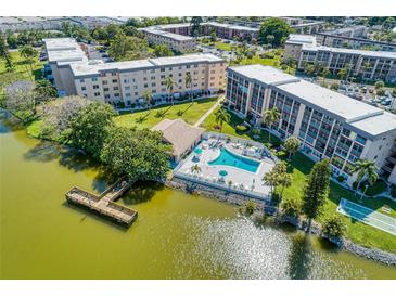 Wonderful aerial view of community, pool, lake with dock and buildings in a park-like setting at 3562 Lake Bayshore Dr # 202, Bradenton, FL 34205