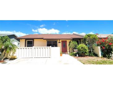 Charming single-story home with a well-manicured front yard and a welcoming red front door at 3915 40Th W St, Bradenton, FL 34205