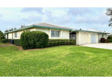 Charming single-story home with a well-manicured lawn and attached garage at 6912 10Th W Ave, Bradenton, FL 34209