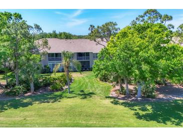 Beautifully maintained condo complex with lush landscaping and manicured lawns creating a serene outdoor environment at 8921 Veranda Way # 325, Sarasota, FL 34238