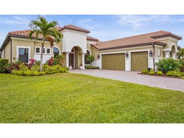 Beautiful single-Gathering home with a tile roof, three-car garage, and lush landscaping at 12020 Legacy Estates Blvd, Sarasota, FL 34238