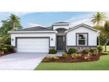 Charming single-Gathering home featuring a two-car garage, well-manicured lawn, and tropical landscaping at 17917 Tavernside Trl, Lakewood Ranch, FL 34211