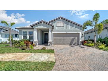 Charming home with a brick driveway, two-car garage, and lush landscaping for added curb appeal at 4725 Antrim Dr, Sarasota, FL 34240