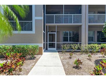 Charming condo with covered porch, lush landscaping, and well-maintained walkway at 5320 Hyland Hills Ave # 2214, Sarasota, FL 34241