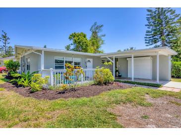 Charming single-story home with well-manicured lawn and covered porch at 5675 Saint Louis Ave, Sarasota, FL 34233
