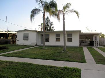 Modest single-story home featuring a well-kept lawn and two palm trees in front at 6339 Pontiac Ln, North Port, FL 34287